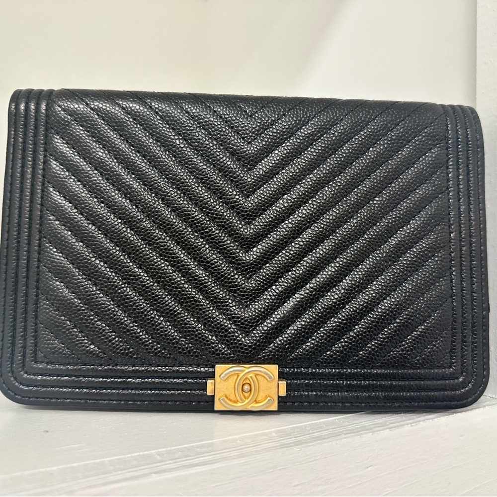 Chanel Boy Bag, specifically in caviar leather with chevron quilting.